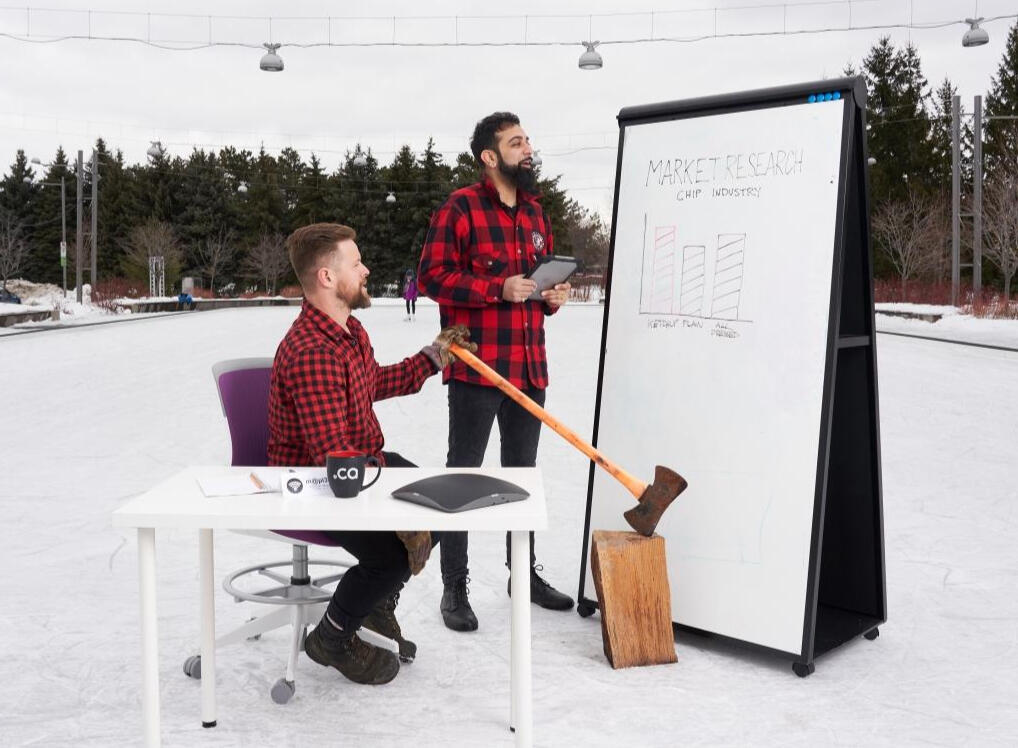 Two Canadians looking at a large chart. This is a funny image, and looks nothing like what working with me is like.